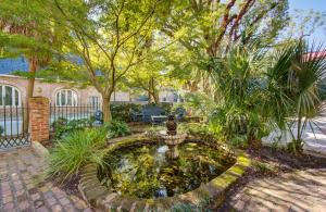 a garden with a fountain in the middle of a yard at The Ashley Inn in Charleston