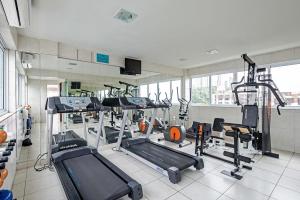 a gym with several tread machines in a room at Rede Andrade Solmar in João Pessoa