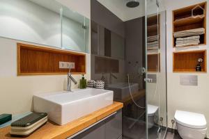 a bathroom with a white sink and a toilet at Alster 36 - Exklusives City Apartment in Hamburg