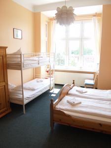 a bedroom with two bunk beds and a window at Happy Go Lucky Hotel + Hostel in Berlin