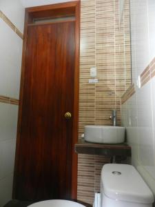 a bathroom with a toilet and a sink at Departamento Marifer in Tacna