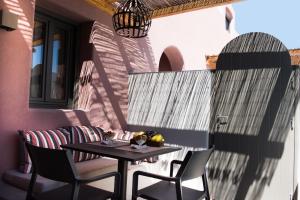 a table and chairs sitting on a patio at Terra Nera Suites in Perivolos