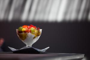 a dessert with fruit in a glass bowl on a table at Terra Nera Suites in Perivolos