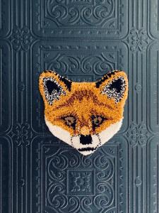 a mask of a fox is hanging on a wall at Fab House - Les Maisons Fabuleuses in Senlis