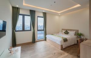 Postel nebo postele na pokoji v ubytování Maris Da Nang Hotel & Apartment