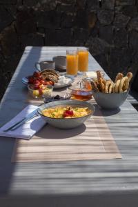 a table with breakfast foods and drinks on it at Terra Nera Suites in Perivolos