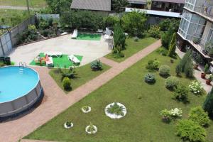 an aerial view of a garden with a swimming pool at Skarlett Guest House in Lazarevskoye