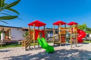 a playground in front of a house at Del Garda Village and Camping in Peschiera del Garda