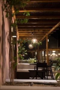 a patio with a table and a bench and lights at Terra Nera Suites in Perivolos