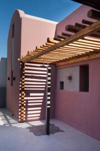 a house with awning on the side of it at Terra Nera Suites in Perivolos