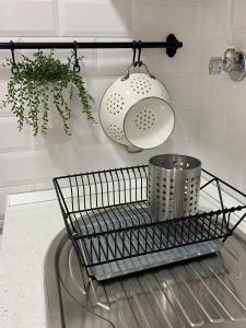 a kitchen counter with a basket and a light at Guest House AltoNível in Viana do Castelo +19 photos