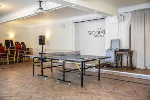 a ping pong table in a room with chairs at The Woodside Hotel Aberdour Exclusive Use in Aberdour