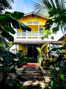 a house with a green roof and a yellow house at Barrbra BnB Over The Sea in Bocas Town