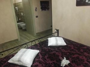 a bedroom with a bed with two white towels on it at Lilium in LʼAquila