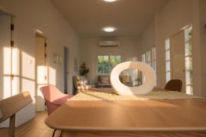 a white object sitting on top of a wooden table at Stayokay Sattahip - Flat House in Sattahip