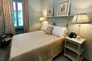 a bedroom with a bed and a lamp on a table at Relais Del Maro in Borgomaro