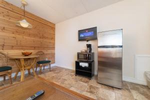 a kitchen with a stainless steel refrigerator and a table at Steinhatchee River Inn and Marina in Steinhatchee
