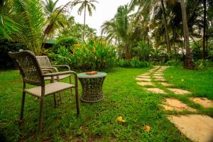 two chairs and a table in a yard at Montego Bay Beach Village in Morjim