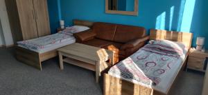 a living room with a couch and a bed at Ubytování u Kováře in Ústí nad Labem