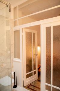 a glass door in a bathroom with a shower at huisalfons in Mechelen