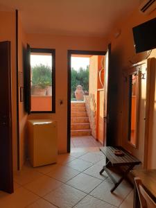 a hallway with a door open to a room with stairs at Sole del Mediterraneo in Otranto