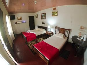 En eller flere senge i et værelse på Cabañas Colibrí Tayutic
