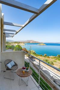 a balcony with a view of the water at Almyrida Panorama II BY APOKORONAS-VILLAS in Almyrida