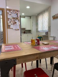 a kitchen with a wooden table in a room at Puerto De la Cruz in Madrid