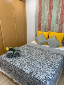 a bedroom with a large bed with yellow and gray sheets at Puerto De la Cruz in Madrid