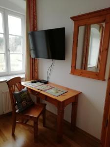 a wooden table with a television on a wall at Mayr-Eichberg, Familie Berndl in Wolfsbach
