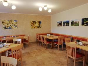 a dining room with tables and chairs and paintings on the walls at Mayr-Eichberg, Familie Berndl in Wolfsbach +12 photos