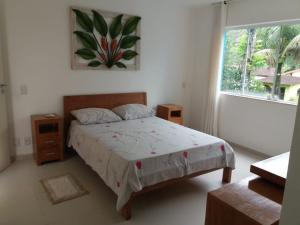 a bedroom with a large bed and a window at Paraiso em Angra dos Reis in Angra dos Reis +87 photos