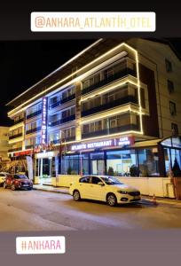 a white car parked in front of a building at ANKARA ATLANTİK OTEL in Etimesut