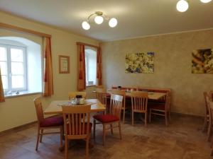 a dining room with wooden tables and chairs at Mayr-Eichberg, Familie Berndl in Wolfsbach