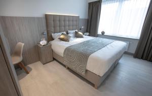 
A bed or beds in a room at Hotel Atlanta Knokke
