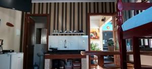 a kitchen with a counter top and a refrigerator at Cantinho da Família in Penha