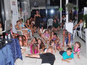 a group of children sitting on the floor in a room at Hotel La Cappuccina in Riccione