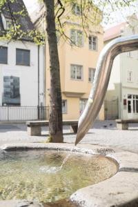 a water fountain in front of a building at Altstadt Charme in Augsburg