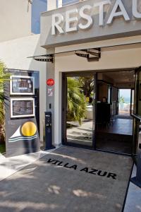 a entrance to a restaurant with a sign on the door at Villa Azur in Villeneuve-Loubet