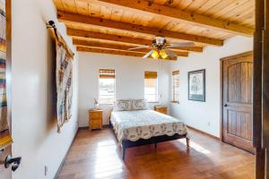 a bedroom with a bed and a ceiling fan at The Urban Ranch in Tucson