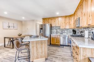 a large kitchen with wooden cabinets and a table at Heavenly Hideaway in Stateline