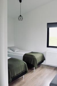 a bedroom with a bed and a desk at iStay Cottages in Sandgerði