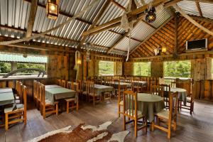 a restaurant with tables and chairs in a building at Capivari Ecoresort in Campina Grande do Sul +28 photos
