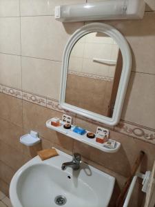 a bathroom with a sink and a mirror at appartement plage Bouznika in Bouznika +10 photos