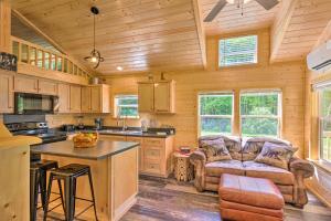 a kitchen with a couch and a table in a room at Quaint Mtn Cabin Tiny Living Near Big Adventure in Brevard