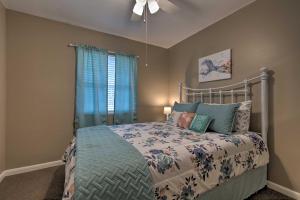 a bedroom with a bed and a ceiling fan at Breezy Gulfport Getaway Less Than 1 Mile to Beach and Casino in Gulfport