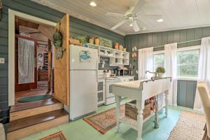 a kitchen with green walls and a white refrigerator at Island Escape with Slip and Lift - Boat Access Only! in Georgetown