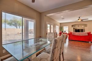 a living room with a glass table and a red couch at Maricopa Home with Outdoor Seating, 2 Mi to Golf! in Maricopa
