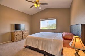 a bedroom with a bed and a flat screen tv at Maricopa Home with Outdoor Seating, 2 Mi to Golf! in Maricopa