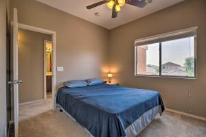 a bedroom with a blue bed and a window at Maricopa Home with Outdoor Seating, 2 Mi to Golf! in Maricopa
